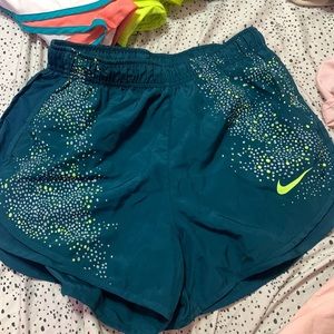 reflective teal and green nike shorts, size small